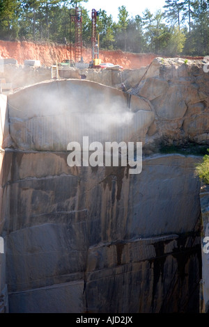 Workers drilling and cutting blocks at a granite quarry in Elberton Georgia Stock Photo