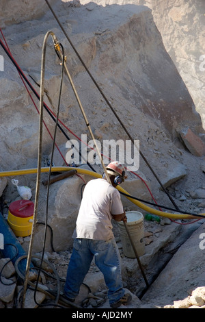 Worker drilling in a granite quarry in Elberton Georgia Stock Photo