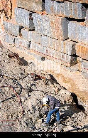 Worker drilling in a granite quarry in Elberton Georgia Stock Photo