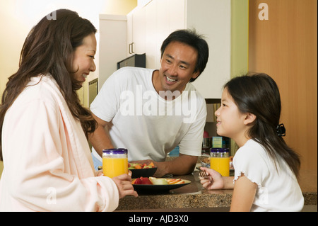 Family Enjoying Breakfast in kitchen Stock Photo