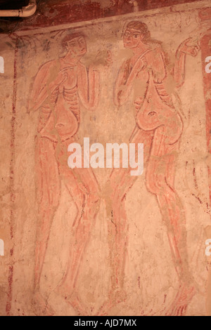 Early Christian medieval wall painting depicting Eve tempting Adam with the Serpent to the right in St Botolphs Church, Hardham, West Sussex. UK Stock Photo