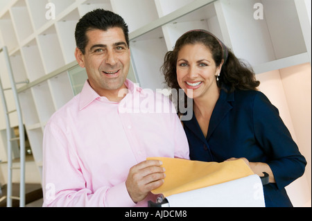 Couple Examining Fabric Swatches in furniture store, portrait