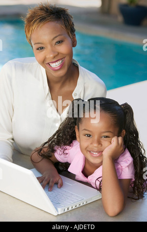 Mother and Daughter Using Laptop on patio, portrait, high angle view Stock Photo