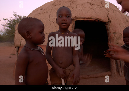 Namibia Kaokoland Himba people Himba children outside village hut Stock Photo