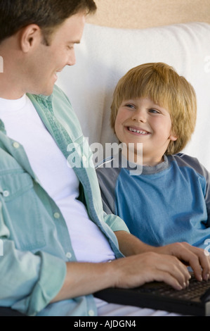 Father and Son Using Laptop Together Stock Photo