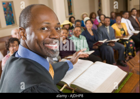 Preacher at altar with Bible preaching to Congregation, portrait, close up Stock Photo