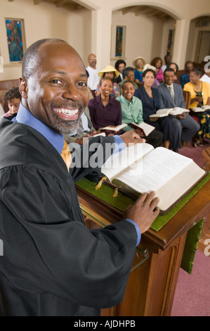 Preacher at altar with Bible preaching to Congregation, portrait Stock Photo