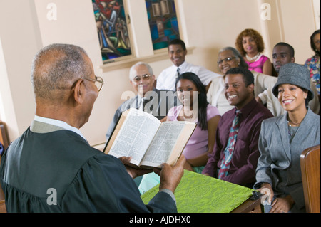 Minister Giving Sermon to congregation in Church, back view Stock Photo