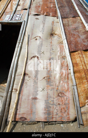 A traditional family innu tent made of birch bark and tree trunk ...