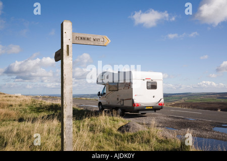 Pennine Way finger post sign beside A635 with motorhome parked in Peak District National Park, Yorkshire, England, UK. Stock Photo