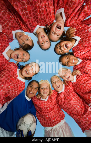 Girls' soccer team (13-17) in huddle, view from below Stock Photo