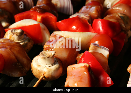 skewered meat and vegetables on a grilling pin ready to be grilled Stock Photo