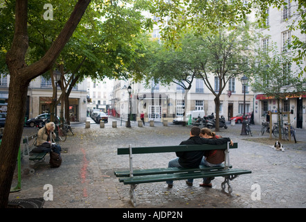 Couple on a bench on Place du Marche Saint Honore Stock Photo