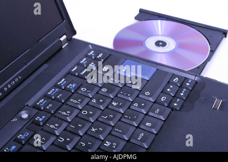 brand new laptop with cd in open cd drive shot on white Stock Photo