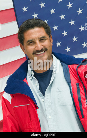 Man standing in front of American flag, (portrait) Stock Photo