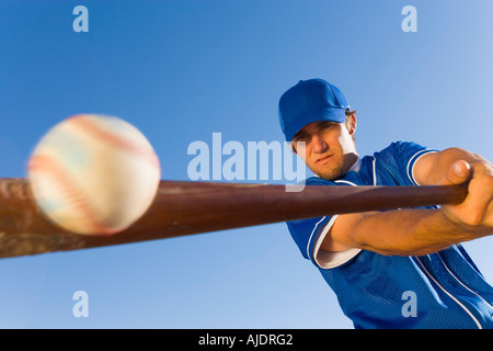 Baseball player hitting ball with bat, (low angle view) Stock Photo