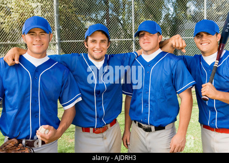 Four baseball team-mates posing on field, (portrait) Stock Photo