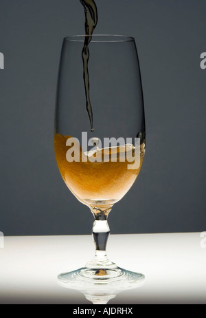Beer being poured into a glass Stock Photo