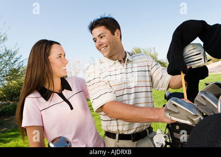 Couple of golfers chatting on golf course Stock Photo