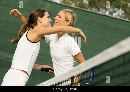 Tennis Players Hugging Each Other over net After Match Stock Photo
