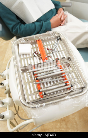 Close-up view of dentist's hands with a human jaw layout and a floss ...