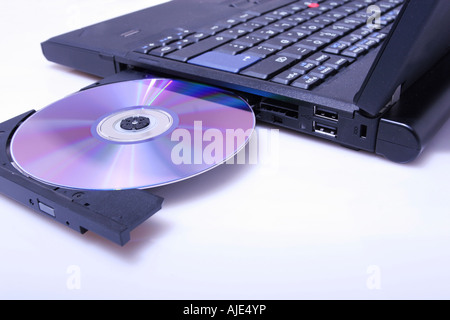 brand new laptop with cd in open cd drive shot on white Stock Photo