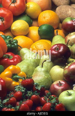 Cornucopia of mixed fruits and vegetables including apples pears strawberries oranges lemons limes peppers and potatoes Stock Photo