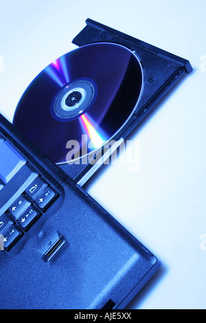 brand new laptop with cd in open cd drive shot on white
