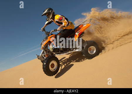 Man riding quad bike in desert, close up Stock Photo