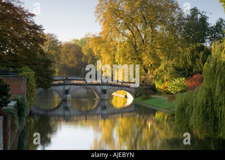 Ancient Clare bridge with autumn colours and reflections bathed in early morning sunlight on the river Cam Cambridge Stock Photo