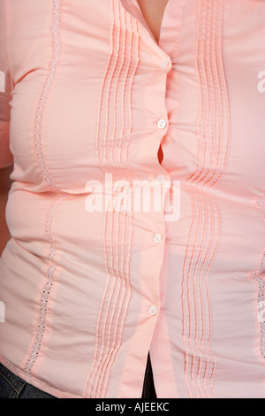 Overweight Woman in tight blouse, mid section, front view Stock Photo