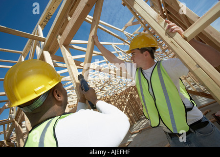 Two Construction Workers wearing hardhats, working on Site Stock Photo