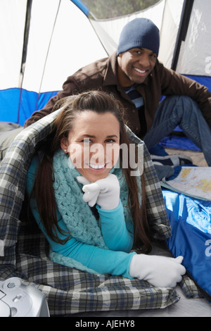 Young couple relaxing in tent. Stock Photo