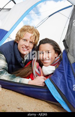 Young Couple Lying Down in Tent. Stock Photo