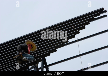 Builder works on new roof after tsunami Khao Lak Thailand Stock Photo