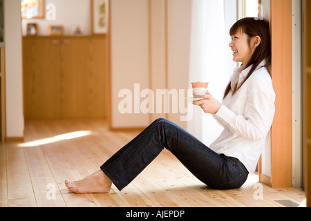 Young woman having cup of coffee Stock Photo