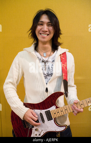 Young man playing electric guitar Stock Photo