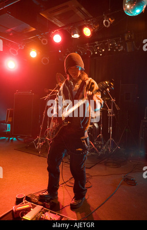 Young man playing electric guitar on stage Stock Photo