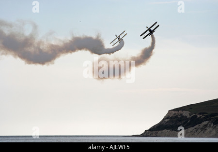 Utterly butterly wing walkers display team 2 1940 s super stearman biplanes with daredevils on the top wing of the aircraft Pe Stock Photo