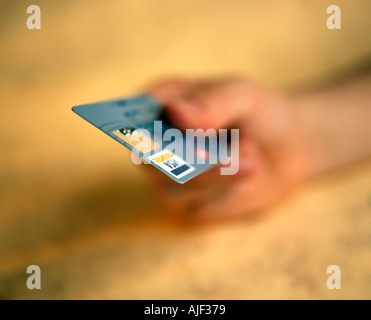 Mans hand offering a credit card Stock Photo