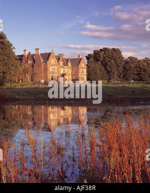 Launde Abbey Leicestershire reflected in the pond at dusk on a clear summers evening Stock Photo