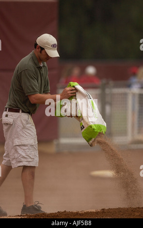 Field crew does maintenance to the baseball field between games  Stock Photo