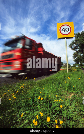 lorry passing 40 miles per hour speed limit warning sign on country road uk Stock Photo