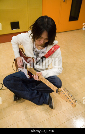 Young man playing electric guitar Stock Photo