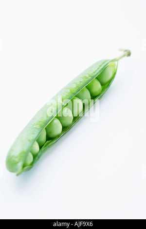 Open pea pod containing peas, close-up Stock Photo