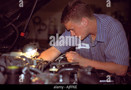 Mechanic working on car engine Stock Photo