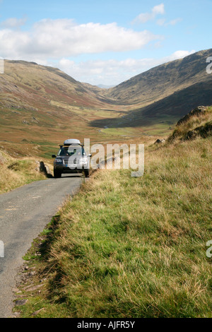 Car reaching the top of the Wrynose Pass, Cumbria, England Stock Photo