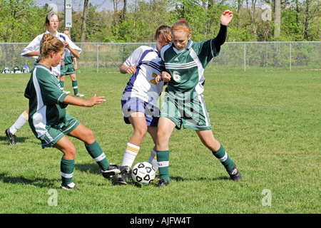 Teenage girls involved in High School Soccer action Stock Photo