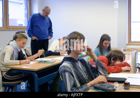 teenager talking on his mobile phone during class Stock Photo