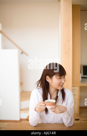Young woman having cup of coffee Stock Photo